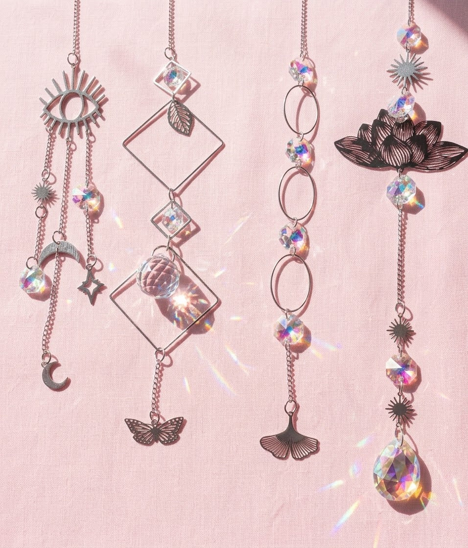 Celestial-inspired hanging sun catchers with reflective crystal-look drops and moon, star, butterfly, lotus, and geometric accents.